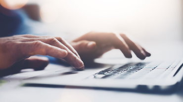 Hands typing on keyboard