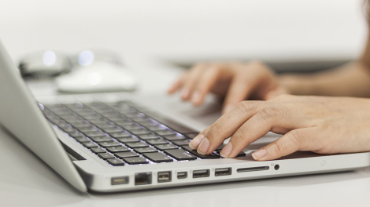 Female hands typing on keyboard